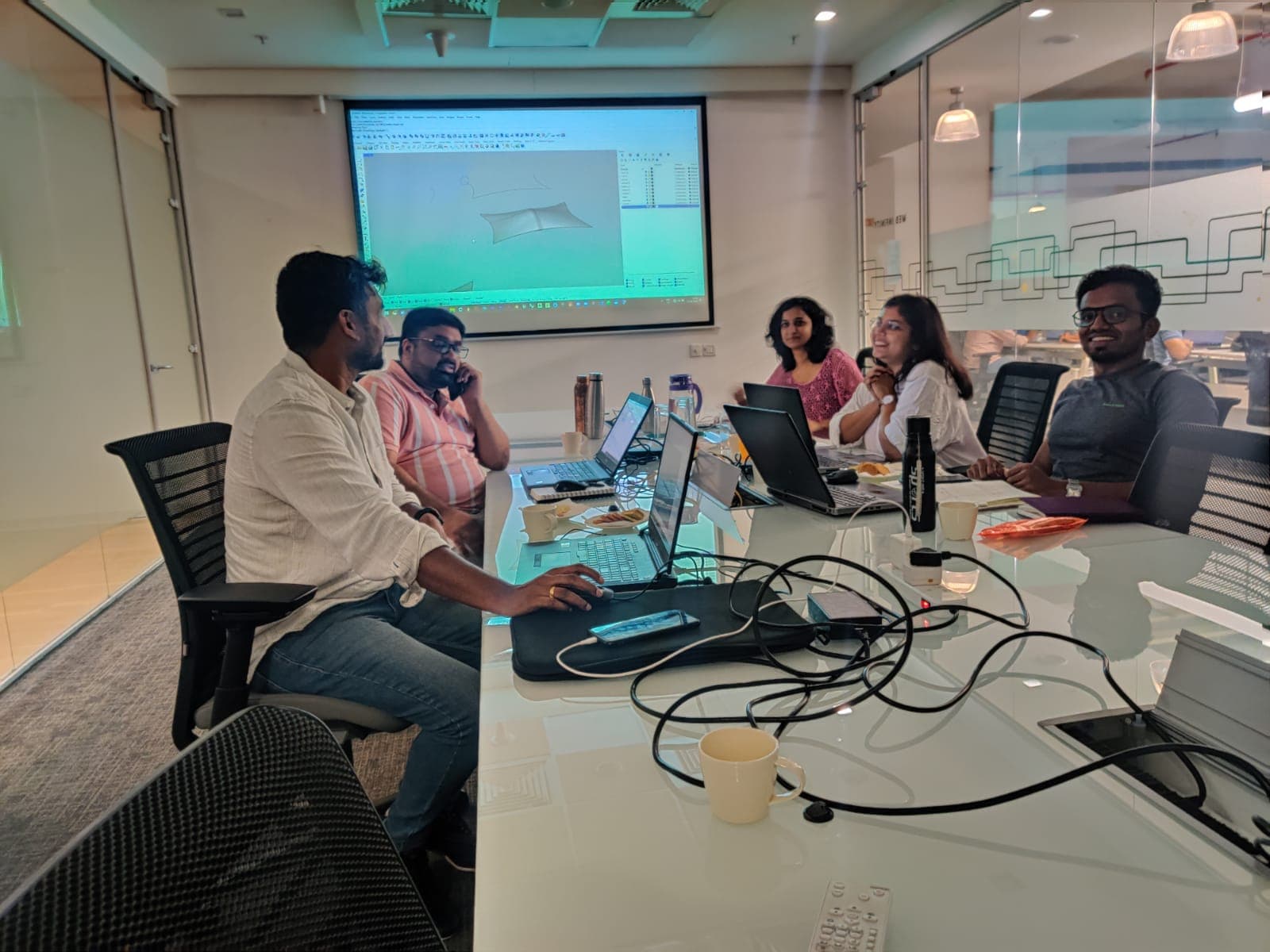 Professionals attending a practical software training session with a presentation on screen